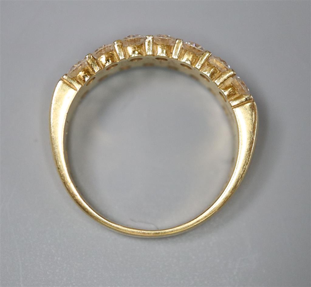 A modern 18ct gold and fifteen stone two row diamond set half hoop ring, size O, gross 6.6 grams.